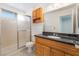 Bathroom with wood vanity, black countertop, and shower stall at 4406 Flowerdale Ct, Las Vegas, NV 89103