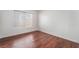 Cozy bedroom featuring wood floors and bright natural light from the window at 4406 Flowerdale Ct, Las Vegas, NV 89103