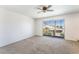 Bright bedroom with neutral carpet and a sliding glass door at 4406 Flowerdale Ct, Las Vegas, NV 89103