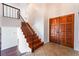 Home entryway featuring wood front doors, tile flooring and staircase at 4406 Flowerdale Ct, Las Vegas, NV 89103