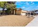This is a front yard view of the home in its neighborhood at 4406 Flowerdale Ct, Las Vegas, NV 89103