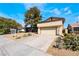 The front of this home features a driveway, garage and xeriscaping at 4406 Flowerdale Ct, Las Vegas, NV 89103