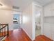 Hallway featuring hardwood floors, white walls, storage, and access to the bathroom at 4406 Flowerdale Ct, Las Vegas, NV 89103