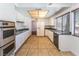 Bright kitchen with stainless steel appliances, white cabinetry and tile floor at 4406 Flowerdale Ct, Las Vegas, NV 89103