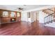 Inviting living room with brick fireplace, hardwood floors, and staircase leading to upper level at 4406 Flowerdale Ct, Las Vegas, NV 89103