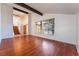 Bright living room with exposed beams, hardwood floors, and staircase at 4406 Flowerdale Ct, Las Vegas, NV 89103