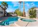Backyard pool and spa with tropical landscaping, perfect for outdoor relaxation and entertainment at 4406 Flowerdale Ct, Las Vegas, NV 89103