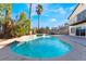 Inviting backyard pool features a spa and cool decking perfect for outdoor entertaining and relaxation at 4406 Flowerdale Ct, Las Vegas, NV 89103