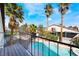 Balcony view of the backyard pool and mature palm trees creates a tropical oasis for relaxation and enjoyment at 4406 Flowerdale Ct, Las Vegas, NV 89103