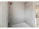 Modern bathroom with light stone tile, stylish bathtub and shower fixtures in elegant home at 501 Proud Eagle Ln, Las Vegas, NV 89144
