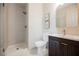 Modern bathroom featuring a sleek shower with white textured tile and a stylish vanity with gold fixtures at 501 Proud Eagle Ln, Las Vegas, NV 89144