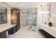 Modern bathroom with dual vanities, a glass-enclosed shower, and sleek, contemporary fixtures at 501 Proud Eagle Ln, Las Vegas, NV 89144