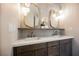 Elegant bathroom with double vanity, marble countertop, stylish mirrors, and modern pendant lighting at 501 Proud Eagle Ln, Las Vegas, NV 89144