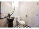 Stylish powder room featuring modern fixtures, a unique vessel sink and a decorative chandelier at 501 Proud Eagle Ln, Las Vegas, NV 89144