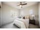 Bright bedroom with neutral tones, large windows, and a comfortable bed with decorative pillows and lamps at 501 Proud Eagle Ln, Las Vegas, NV 89144