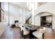 Elegant dining room with a fireplace, floor-to-ceiling windows, and an open-concept design at 501 Proud Eagle Ln, Las Vegas, NV 89144