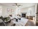 Cozy living room with a fireplace, neutral-toned furnishings, and ample natural light at 501 Proud Eagle Ln, Las Vegas, NV 89144