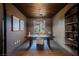 Well-appointed home office with wood ceiling, modern lighting, custom built-ins, and ample natural light at 501 Proud Eagle Ln, Las Vegas, NV 89144
