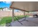 Covered patio in backyard with a hammock, grill, and a view of the lawn at 5988 Turtle River Ave, Las Vegas, NV 89156