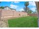 Spacious backyard with lawn, rock features, and a block wall at 5988 Turtle River Ave, Las Vegas, NV 89156