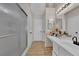 Neutral bathroom with a shower, vanity and wood-look floors at 5988 Turtle River Ave, Las Vegas, NV 89156