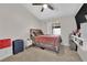 This bedroom features carpet floors, natural light, a ceiling fan, and neutral decor at 5988 Turtle River Ave, Las Vegas, NV 89156