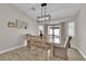 Bright dining room features modern lighting, wood floors, and sliding glass door at 5988 Turtle River Ave, Las Vegas, NV 89156