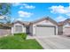 Single-story home with a two-car garage, neutral paint, and green front lawn at 5988 Turtle River Ave, Las Vegas, NV 89156