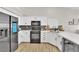 Charming kitchen features modern stainless steel appliances, white cabinetry, and a stylish gray subway tile backsplash at 5988 Turtle River Ave, Las Vegas, NV 89156