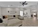 Bright living room boasts vaulted ceiling, ceiling fan, and wood-look floors at 5988 Turtle River Ave, Las Vegas, NV 89156