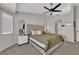 Comfortable bedroom features neutral décor, ceiling fan, and carpet floors at 5988 Turtle River Ave, Las Vegas, NV 89156