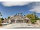 Charming single-story home featuring a three-car garage and desert landscaping with palm trees at 6513 Echo Crest Ave, Las Vegas, NV 89130