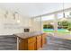 Open concept kitchen with a large island and view of backyard pool at 6513 Echo Crest Ave, Las Vegas, NV 89130