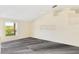 Bright living room with new gray flooring and a large window at 6513 Echo Crest Ave, Las Vegas, NV 89130