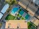 Desirable backyard featuring a private pool, tennis court, putting green, and outdoor lounging areas at 6975 Darby Ave, Las Vegas, NV 89117