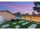 Backyard featuring outdoor living space, lounge seating, fire pit, and spacious covered patio at 6975 Darby Ave, Las Vegas, NV 89117