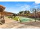 Wide backyard showcasing a tennis court, outdoor seating, a covered patio, and mature trees, ideal for relaxation at 6975 Darby Ave, Las Vegas, NV 89117