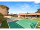 Spacious backyard featuring a well-maintained tennis court, lounge area, and ample space for outdoor activities at 6975 Darby Ave, Las Vegas, NV 89117