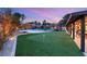 Expansive backyard featuring sport court, putting green, pool, spa and lounge seating at 6975 Darby Ave, Las Vegas, NV 89117