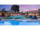Backyard featuring pool, spa, sport court and an array of desert landscaping at 6975 Darby Ave, Las Vegas, NV 89117