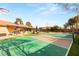 Lush backyard with a tennis court, pool, covered patio, and lounge area, designed for relaxation and entertainment at 6975 Darby Ave, Las Vegas, NV 89117