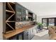Stylish wet bar featuring custom cabinetry, beverage coolers, and backyard access at 6975 Darby Ave, Las Vegas, NV 89117