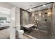 En-suite bathroom featuring a stylish glass-enclosed shower, a soaking tub and access to the main bedroom at 6975 Darby Ave, Las Vegas, NV 89117