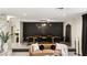 Dining area featuring a long wooden table, accent wall, modern lighting, and stylish chairs at 6975 Darby Ave, Las Vegas, NV 89117