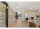 Elegant entryway with tile floors, brick accent wall, and a view of the living room at 6975 Darby Ave, Las Vegas, NV 89117