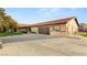 Charming single-story home with a tiled roof, a modern garage door, and a spacious driveway at 6975 Darby Ave, Las Vegas, NV 89117