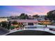 Expansive single-story home featuring a tile roof, manicured lawn, mature trees, and circular driveway at 6975 Darby Ave, Las Vegas, NV 89117