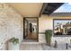 Inviting home entrance featuring stone accents, a stylish front door, and desert landscaping at 6975 Darby Ave, Las Vegas, NV 89117