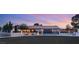 Charming single-story home with updated desert landscape, dark metal gate and vibrant twilight sky at 6975 Darby Ave, Las Vegas, NV 89117