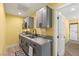 Functional kitchenette with stainless steel sink, gray cabinets, marble countertops, and appliances at 6975 Darby Ave, Las Vegas, NV 89117